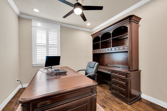 Home office with a ceiling fan, ornamental molding, dark wood-style floors, and recessed lighting | Image 16