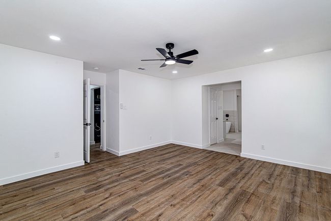 Unfurnished room featuring wood finished floors, a ceiling fan, recessed lighting, and baseboards | Image 20