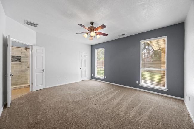 Spacious primary bedroom with views into the beautiful backyard! | Image 13