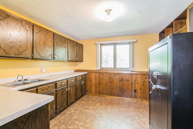 Lower level bonus room has a sink and cabinets! Great craft area, canning room....you name it! | Image 45