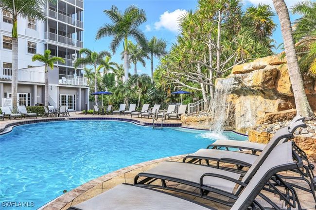 Community pool with a patio area and fence | Image 23
