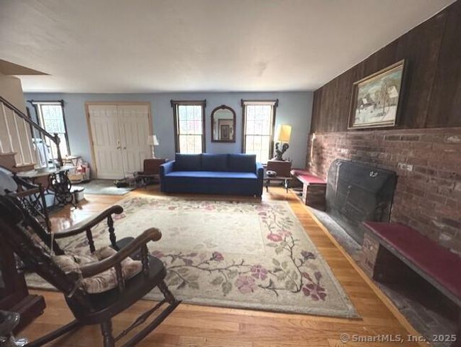 Double door front entry, hardwood floors, lovely fireplace flanked with built ins | Image 6