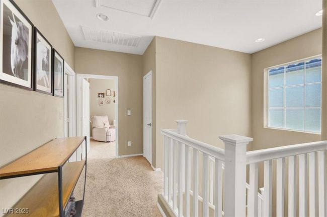 Hallway with carpet floors, an upstairs landing, and baseboards | Image 12