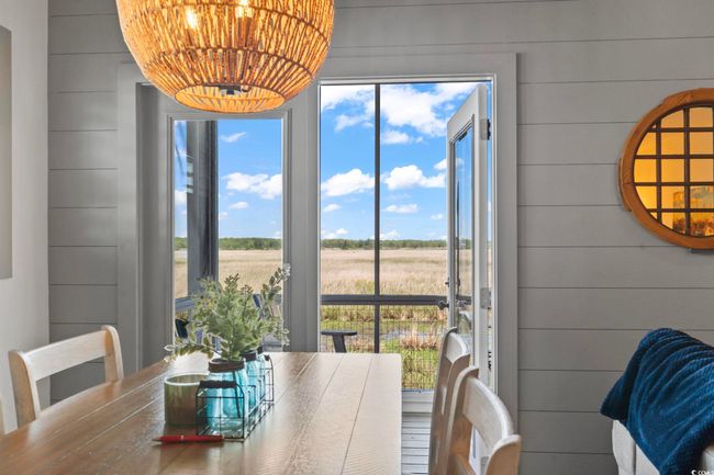 Dining room featuring wooden walls | Image 11