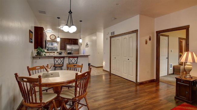 Dining area between living room and kitchen. Washer and Dryer in laundry closet adjacent. | Image 5