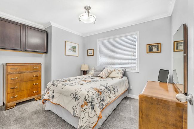Bedroom featuring light carpet, baseboards, and ornamental molding | Image 17