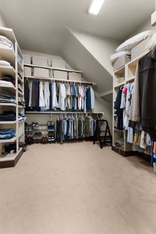 Walk in closet featuring carpet floors and lofted ceiling | Image 16