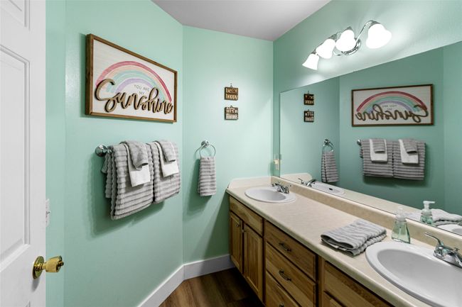 Bathroom featuring double vanity and wood finished floors | Image 64