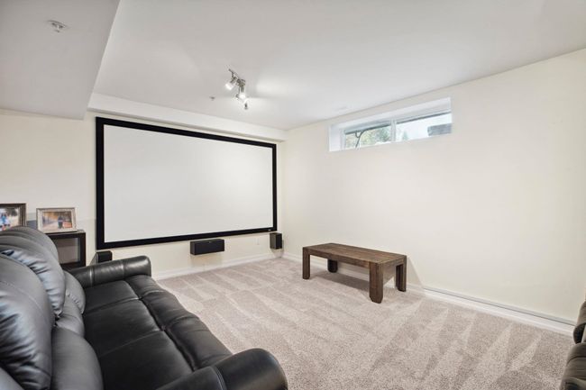 Carpeted cinema with track lighting and baseboards | Image 31