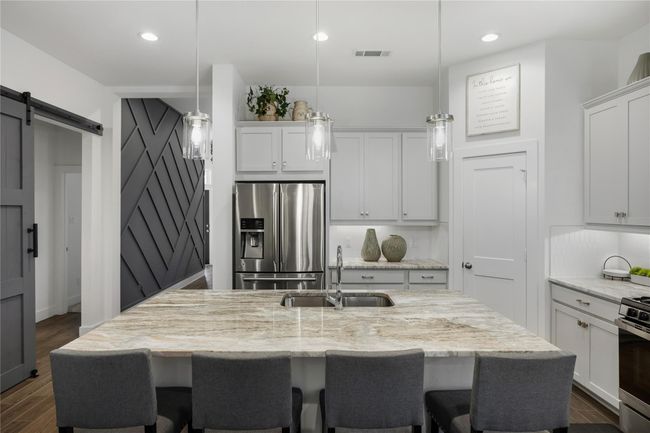 Every detail has been carefully curated, from the sleek backsplash to the modern fixtures and deep stainless sink, this kitchen blends practicality with upscale appeal. | Image 9