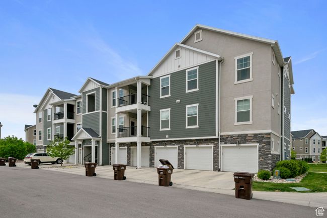 View of building exterior featuring a garage and driveway | Image 28