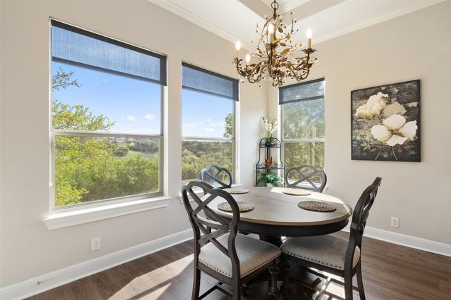 Dining area featuring an inviting chandelier, baseboards, ornamental molding, and dark wood-type flooring | Image 13