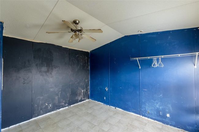 Unfurnished room with vaulted ceiling and ceiling fan | Image 5