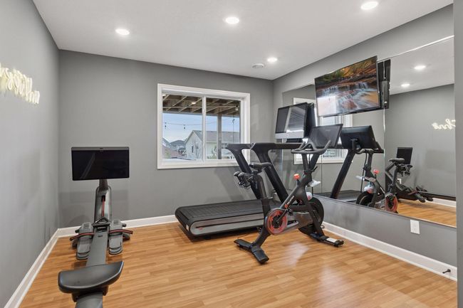 5th bedroom is in the lower level, currently used as a workout room. Walk-in closet. | Image 36