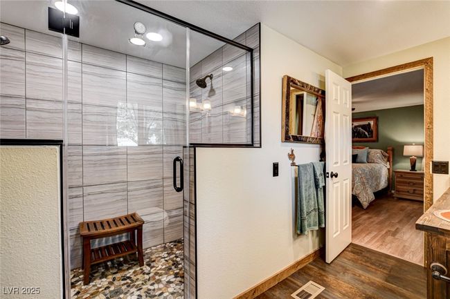 Ensuite bathroom with vanity, a shower stall, and wood finished floors | Image 30
