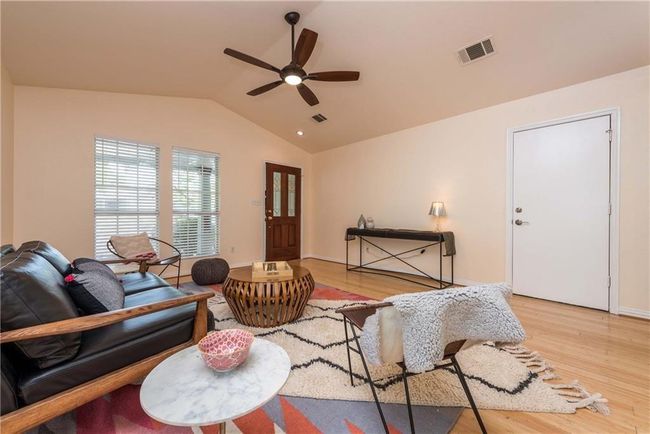 Living room featuring vaulted ceiling, a ceiling fan, and wood finished floors | Image 16