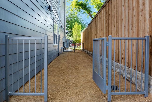 View of side of home featuring a gate and fence | Image 4