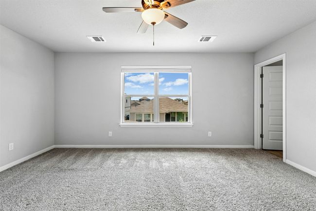 Unfurnished room with carpet and a ceiling fan | Image 24