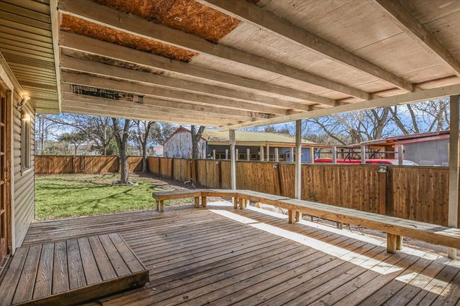 Deck featuring a fenced backyard and a yard | Image 12