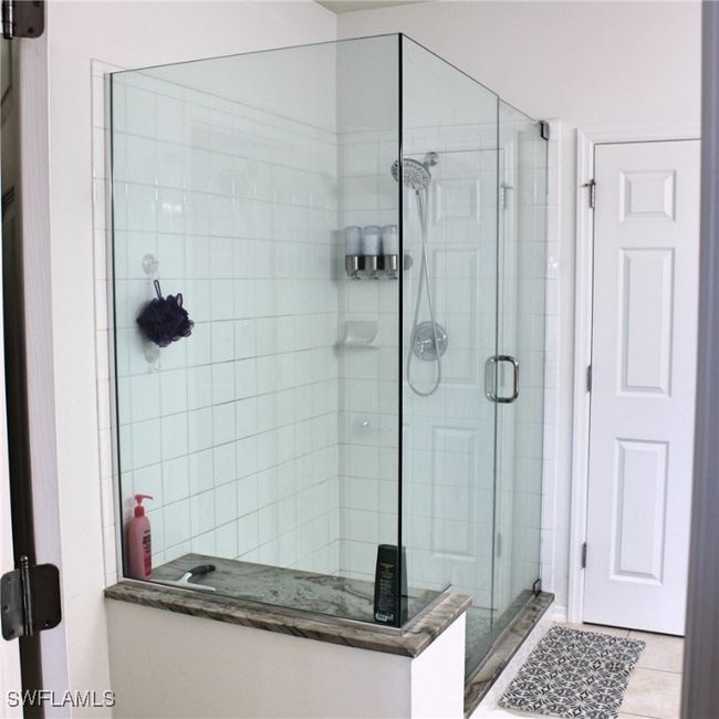 Bathroom with tile patterned flooring and a shower stall | Image 17