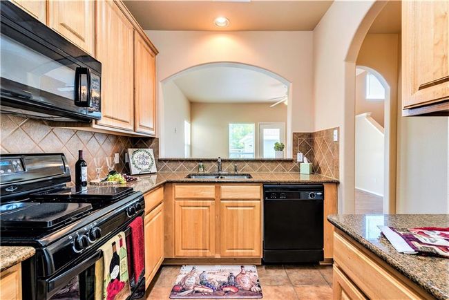 The kitchen opens seamlessly to the living room making it easy to stay connected. | Image 13