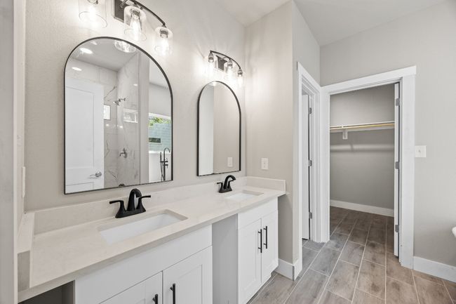 Full bath featuring a sink, a spacious closet, double vanity, and a stall shower | Image 13