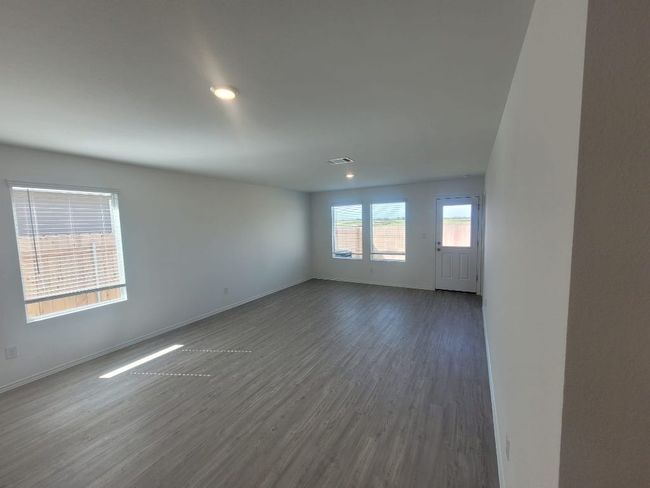 open concept living room featuring wood vinyl finished floors and recessed lighting | Image 4
