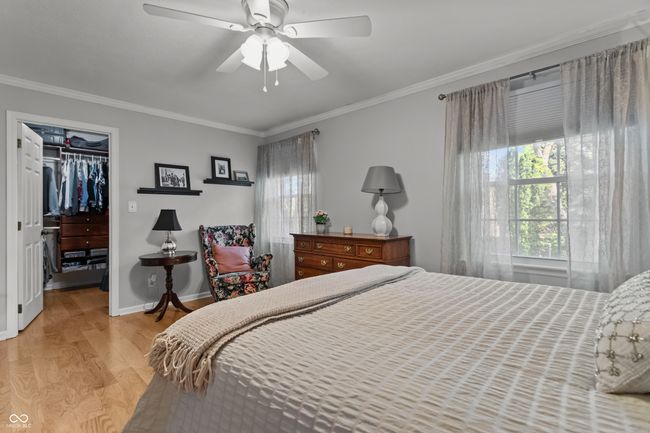 bedroom featuring crown molding, and a walk in closet | Image 19