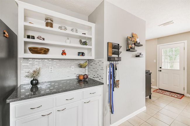 This kitchen cabinet area would make a great coffee station or baking area with room for your cookbooks and favorite kitchen display items. | Image 8