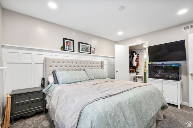 Bedroom featuring carpet floors, recessed lighting, a walk in closet, and a closet | Image 23