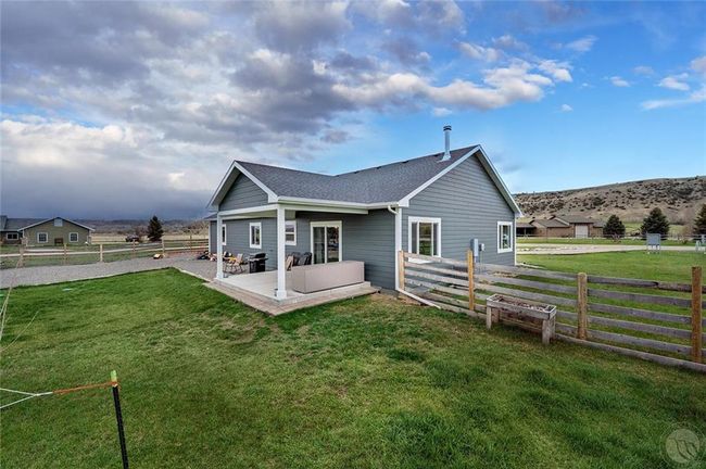 Back of the home showcasing the covered back patio. | Image 28