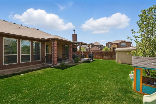 View of yard featuring a patio area and fence | Image 36