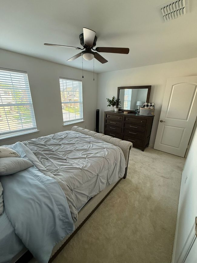 Bedroom featuring light carpet and a ceiling fan | Image 14