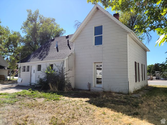 Back of house featuring a chimney and a shingled roof | Image 39