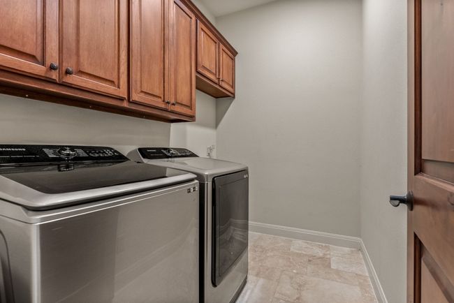 Laundry room with storage. | Image 18