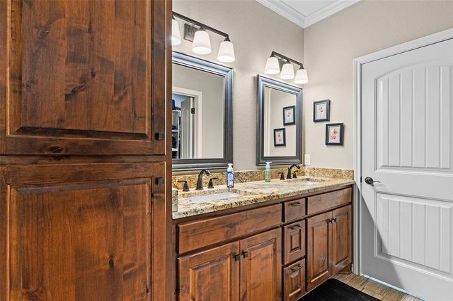 Bathroom with vanity with extensive cabinet space and double sink | Image 16