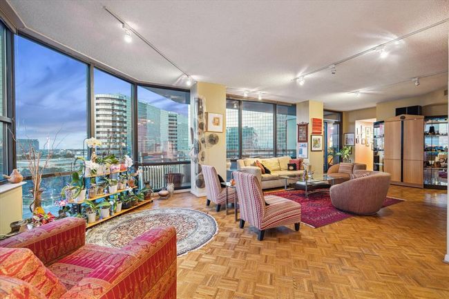 You'll fall in love with the expansive living area, highlighted by walls of windows that bring in stunning natural light. | Image 8