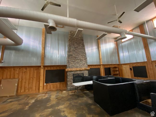 Basement featuring wooden walls and a ceiling fan | Image 29