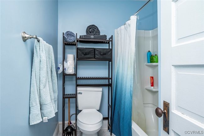 Full bath featuring toilet and shower / bath combination with curtain | Image 25