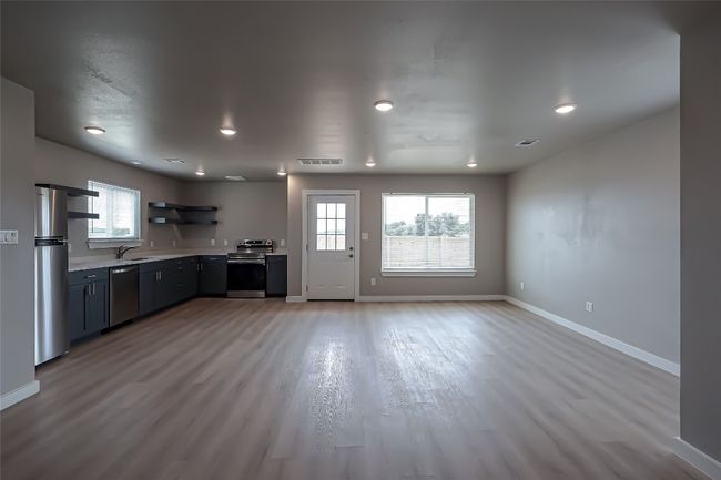 Kitchen with stainless steel appliances, open shelves, light countertops, plenty of natural light, and recessed lighting | Image 19