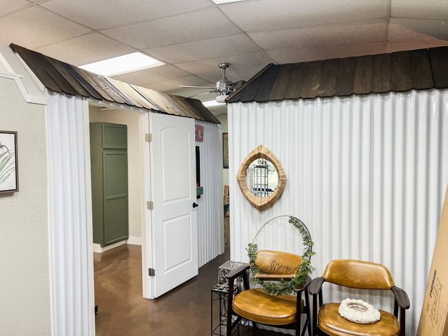 Living area featuring ceiling fan, a drop ceiling, and finished concrete floors | Image 13