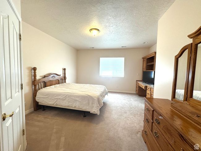 Bedroom featuring built-in cabinets, sink and walk-in closet. | Image 21