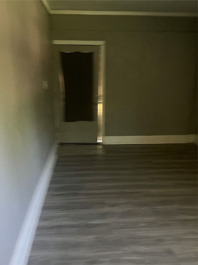 Spare room with baseboards and wood finished floors | Image 16