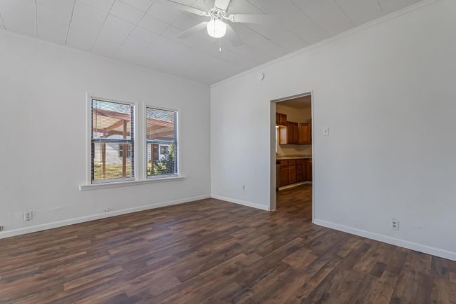 Unfurnished room with ornamental molding, dark hardwood / wood-style floors, and ceiling fan | Image 10