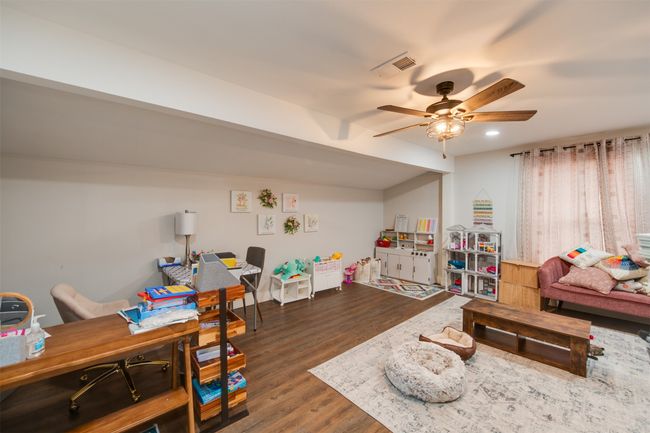 Recreation room with ceiling fan, wood finished floors, visible vents, and recessed lighting | Image 5