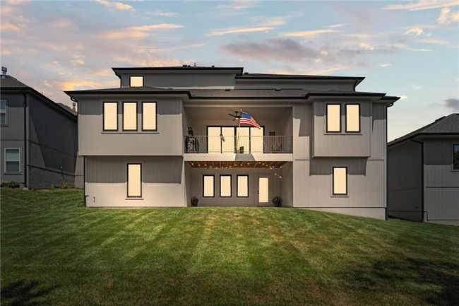 Back of property at dusk with a balcony and a lawn | Image 45