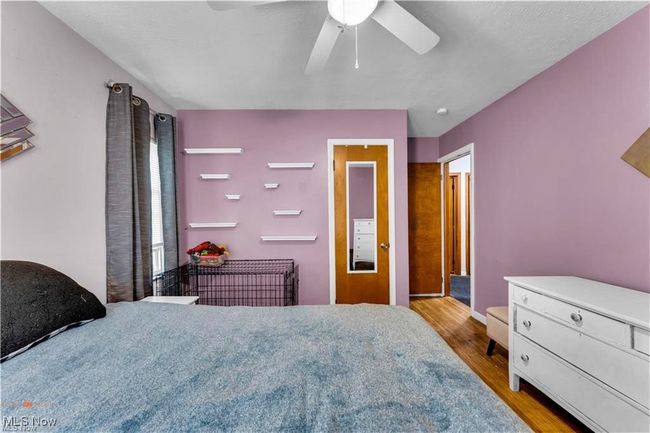 Bedroom with wood finished floors, ceiling fan, and baseboards | Image 18