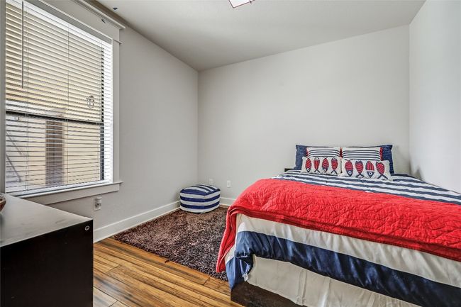Bedroom featuring baseboards and wood finished floors | Image 13