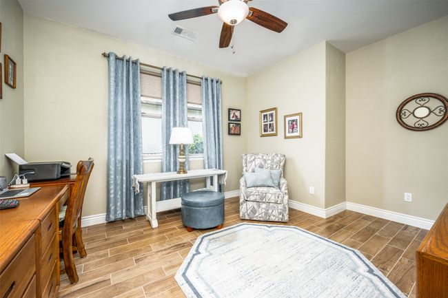 Study with wood finish floors, ceiling fan, spacious | Image 8