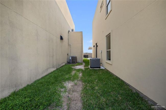 View of side of property featuring stucco siding and a yard | Image 19